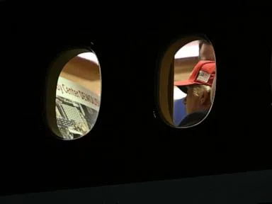 Trump photographed looking over 'Kennedy Center DEMOLISHED' placard